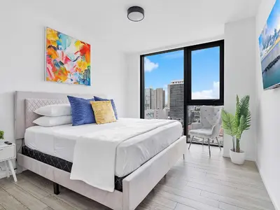 a white bedroom with a bed and a large window at X Lounge VIII-Prime Corner Residence in Miami