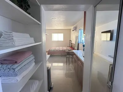a bathroom with a walk in closet with towels at Miramar's Studio in Miramar