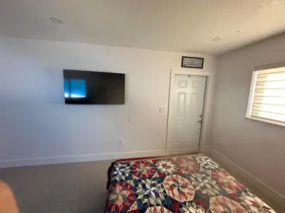 a bedroom with a bed and a flat screen tv at Miramar's Studio in Miramar
