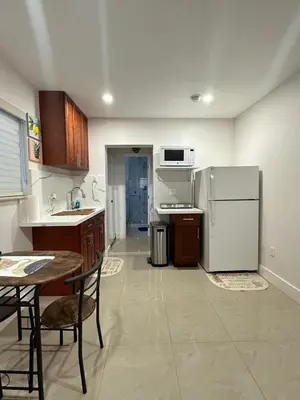 a kitchen with a refrigerator and a table and chairs at Miramar's Studio in Miramar