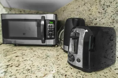 a microwave and a toaster oven on a counter at Family-Friendly Beach Condo Steps to the Ocean- 9th floor in Hollywood Beach