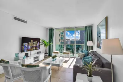a living room with a couch and a table at Family-Friendly Beach Condo Steps to the Ocean- 9th floor in Hollywood Beach