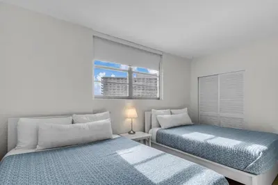 a bedroom with two beds and a window at Family-Friendly Beach Condo Steps to the Ocean- 9th floor in Hollywood Beach