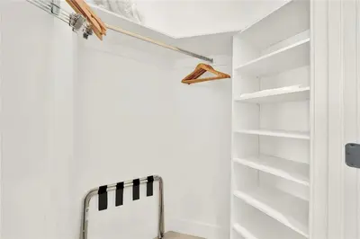 a walk in closet with white walls and white shelves at Oceanfront Escape with Resort-Style Amenities in Hollywood