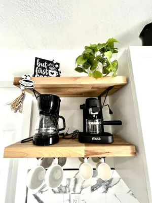 a shelf with a coffee maker and coffee cups on it at Lovely and Private Studio