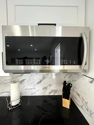 a microwave above a counter in a kitchen at Lovely and Private Studio