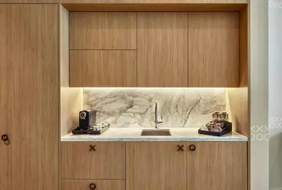 a kitchen with a sink and wooden cabinets at SLS Lux Brickell Exclusive by Palermo Home Miami in Miami