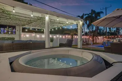 a hot tub in the middle of a patio at night at Prized by Florida |Private Pool and HotTub Oasis| in Fort Lauderdale