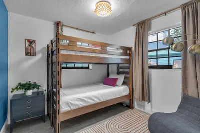 a bedroom with a bunk bed and a chair at Prized by Florida |Private Pool and HotTub Oasis| in Fort Lauderdale