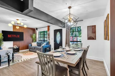 a dining room and living room with a table and chairs at Prized by Florida |Private Pool and HotTub Oasis| in Fort Lauderdale