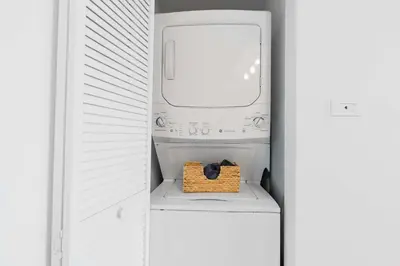 a white refrigerator with a box in the middle at Amazing 2 BR Apartment Pool & Near Beach in Hallandale Beach