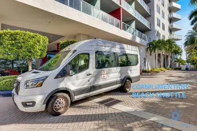 a white van parked in front of a building at Amazing 2 BR Apartment Pool & Near Beach in Hallandale Beach