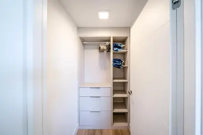 a walk in closet with white cabinets at Bayview Villa by Rove Travel - Waterfront with Patio in Miami Beach
