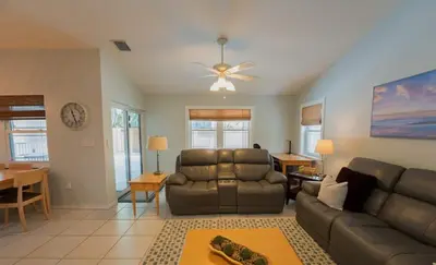 a living room with a couch and a table at Poolside Miami Paradise with BBQ & Outdoor Lounge in Miami