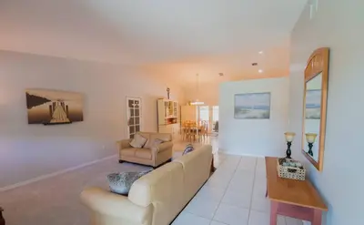 a living room with a couch and a table at Poolside Miami Paradise with BBQ & Outdoor Lounge in Miami