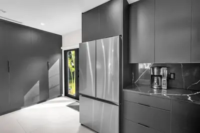 a kitchen with black and white cabinets and a appliance at Buena Vista Oasis - 3BR Home Near Art District Family in Miami