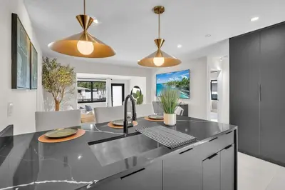 a kitchen with a black counter top and a sink at Buena Vista Oasis - 3BR Home Near Art District Family in Miami