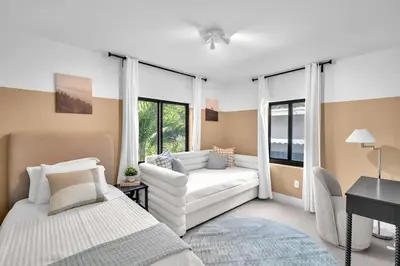 a living room with a white couch and a piano at Buena Vista Oasis - 3BR Home Near Art District Family in Miami