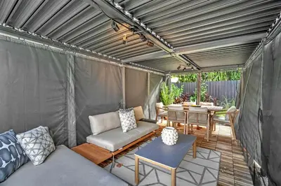 a patio with a couch and a table in a tent at Buena Vista Oasis - 3BR Home Near Art District Family in Miami