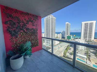 a balcony with a view of the city and the ocean at Luxury Ocean View Penthouse 2501 Hallandale Beach in Hallandale Beach
