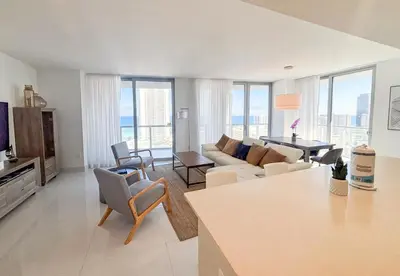 a living room with a couch and a table at Luxury Ocean View Penthouse 2501 Hallandale Beach in Hallandale Beach