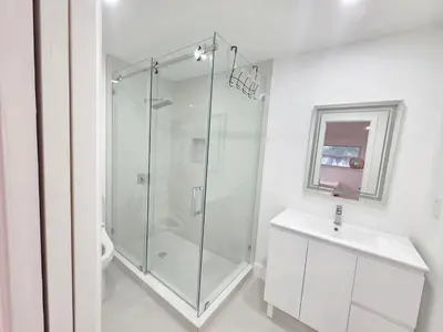 a bathroom with a glass shower and a sink at Modern Home in Hallandale Beach in Hallandale Beach