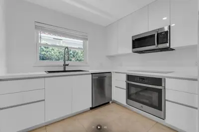 a white kitchen with a sink and a microwave at Modern Home in Hallandale Beach in Hallandale Beach