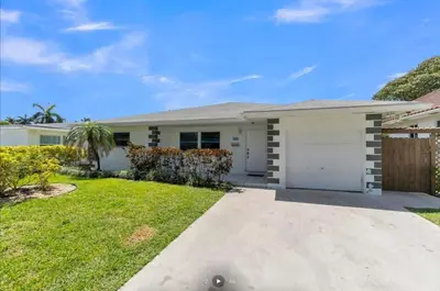 a large white house with a driveway at Modern Home in Hallandale Beach in Hallandale Beach