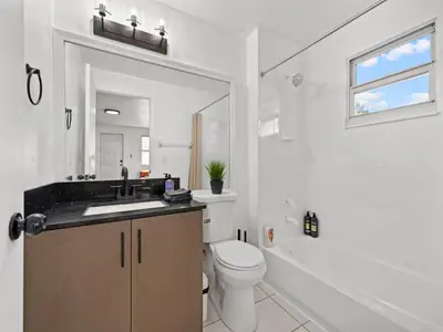 a white bathroom with a sink and a toilet at Studio Sol Little Havana Retreat in Miami
