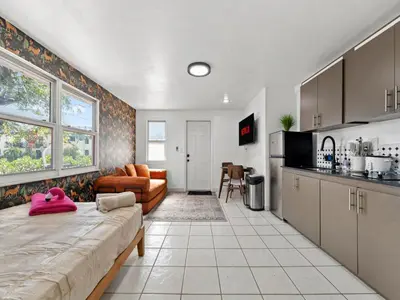 a kitchen and a living room with a large bed at Studio Sol Little Havana Retreat in Miami
