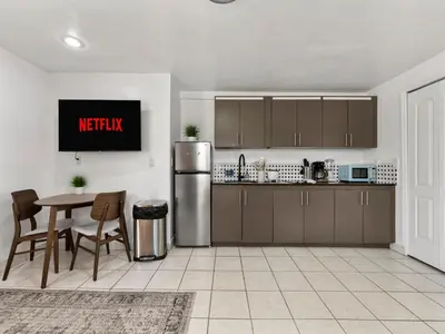a kitchen with a table and a refrigerator at Studio Sol Little Havana Retreat in Miami