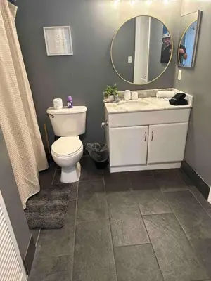a bathroom with a toilet and a sink and a mirror at Stylish 1BR Modern Apt in Brickell - Free Parking in Miami