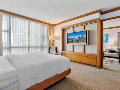 a hotel room with a bed and a flat screen tv at Villa Seafoam in Miami Beach