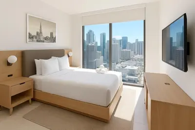 a bedroom with a white bed and a large window at Luxury 3BR Apt with Epic Biscayne Bay Views in Miami