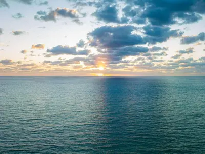 a sunset over a large body of water at Villa DecoBlu in Miami Beach