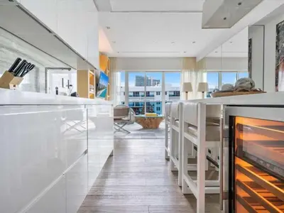 a kitchen with a counter and a fireplace at Villa DecoBlu in Miami Beach