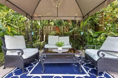 two chairs and a coffee table on a patio at 3-Bedroom Villa with Heated Pool near Wilton Drive & Fort Lauderdale Beach in Fort Lauderdale