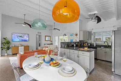a kitchen and living room with a table with food on it at 3-Bedroom Villa with Heated Pool near Wilton Drive & Fort Lauderdale Beach in Fort Lauderdale