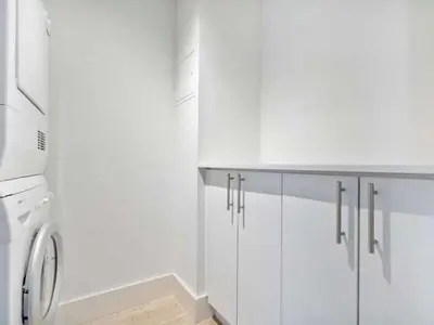 a white laundry room with a washer and dryer at Villa Lumea in Miami Beach