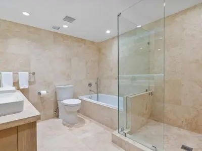 a bathroom with a shower and a toilet and a sink at Villa Lumea in Miami Beach