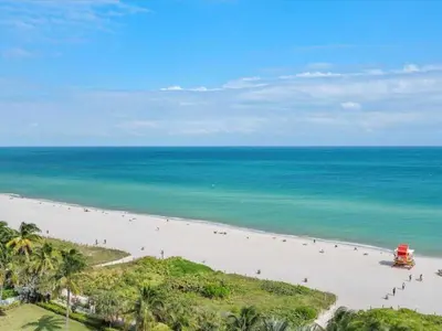 an aerial view of a beach with people on it at Villa Lumea in Miami Beach