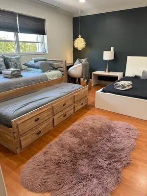 a bedroom with two beds and a rug at The Hollywood Beach Experience in Hollywood