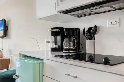 a kitchen with a coffee maker on a stove at Beachfront Studio with Resort Access STR-02630 in Sunny Isles Beach