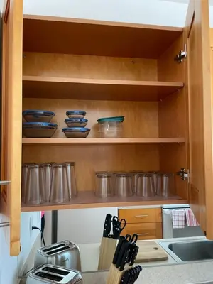 a kitchen with wooden shelves with pots and pans at Beach Escape in Fort Lauderdale