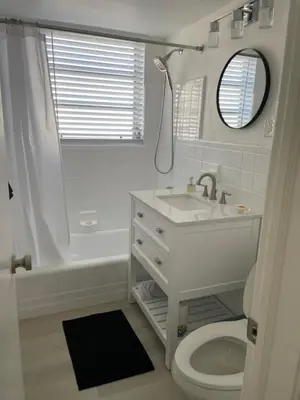 a white bathroom with a sink and a toilet at Beach Escape in Fort Lauderdale