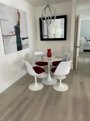 a dining room with a white table and chairs at Beach Escape in Fort Lauderdale