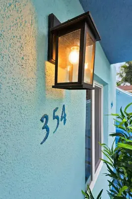 a light hanging on the side of a house with a window at Modern 2-Bedroom Apartment in Miami
