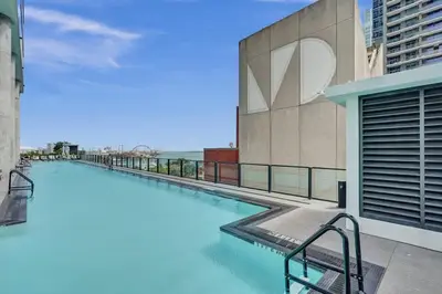 a swimming pool on the side of a building at Miami Lux Studio w. Kitchen City and Bay Views in Miami