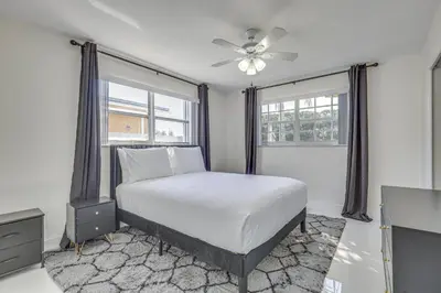 a bedroom with a bed and a ceiling fan at 3 Mi to Hard Rock Stadium Home with Fenced-In Yard! in Miramar