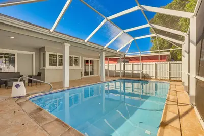 a large swimming pool with a glass roof at 3 Mi to Hard Rock Stadium Home with Fenced-In Yard! in Miramar